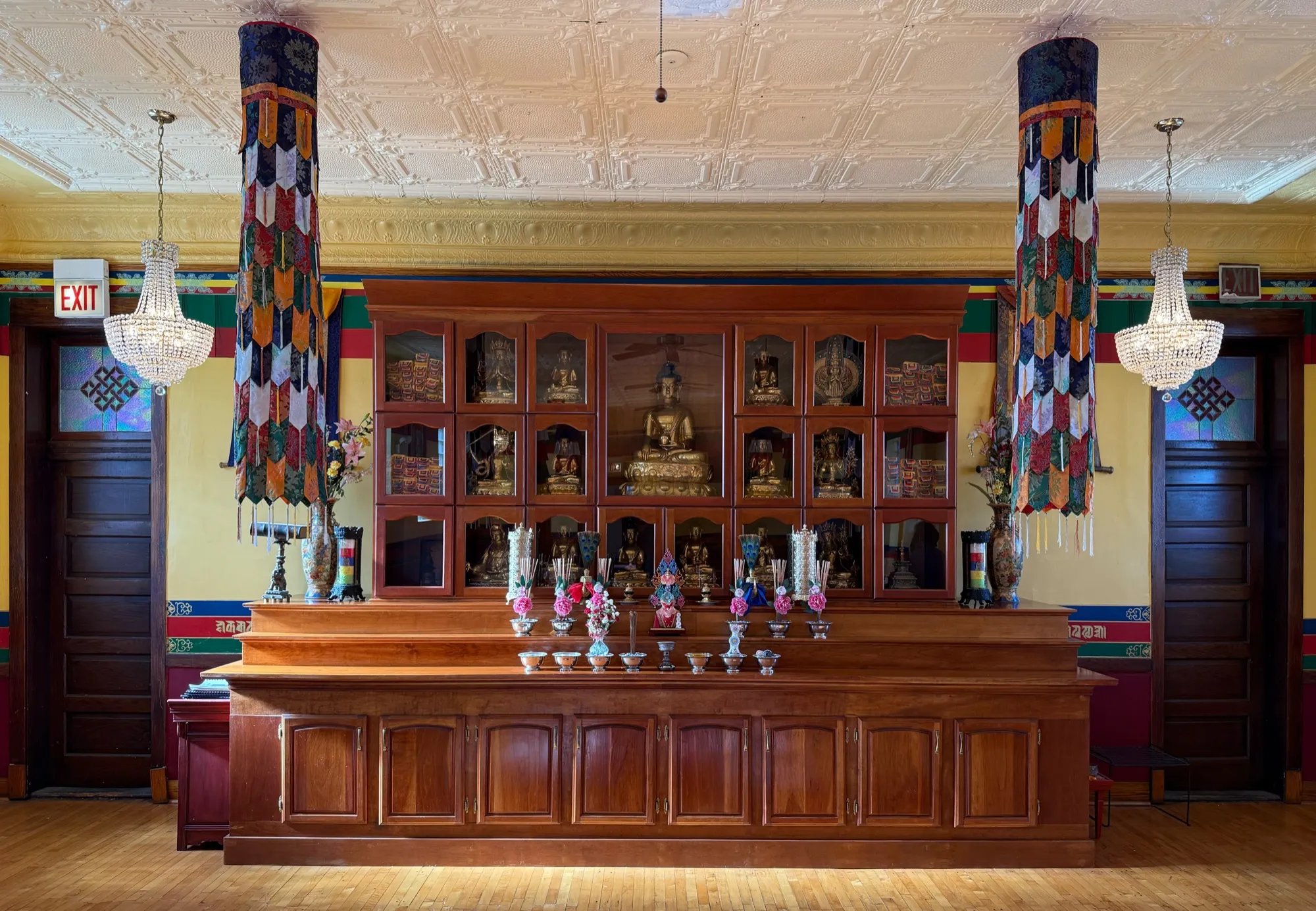 The gold-leafed Buddha statue in its community-built shrine cabinet